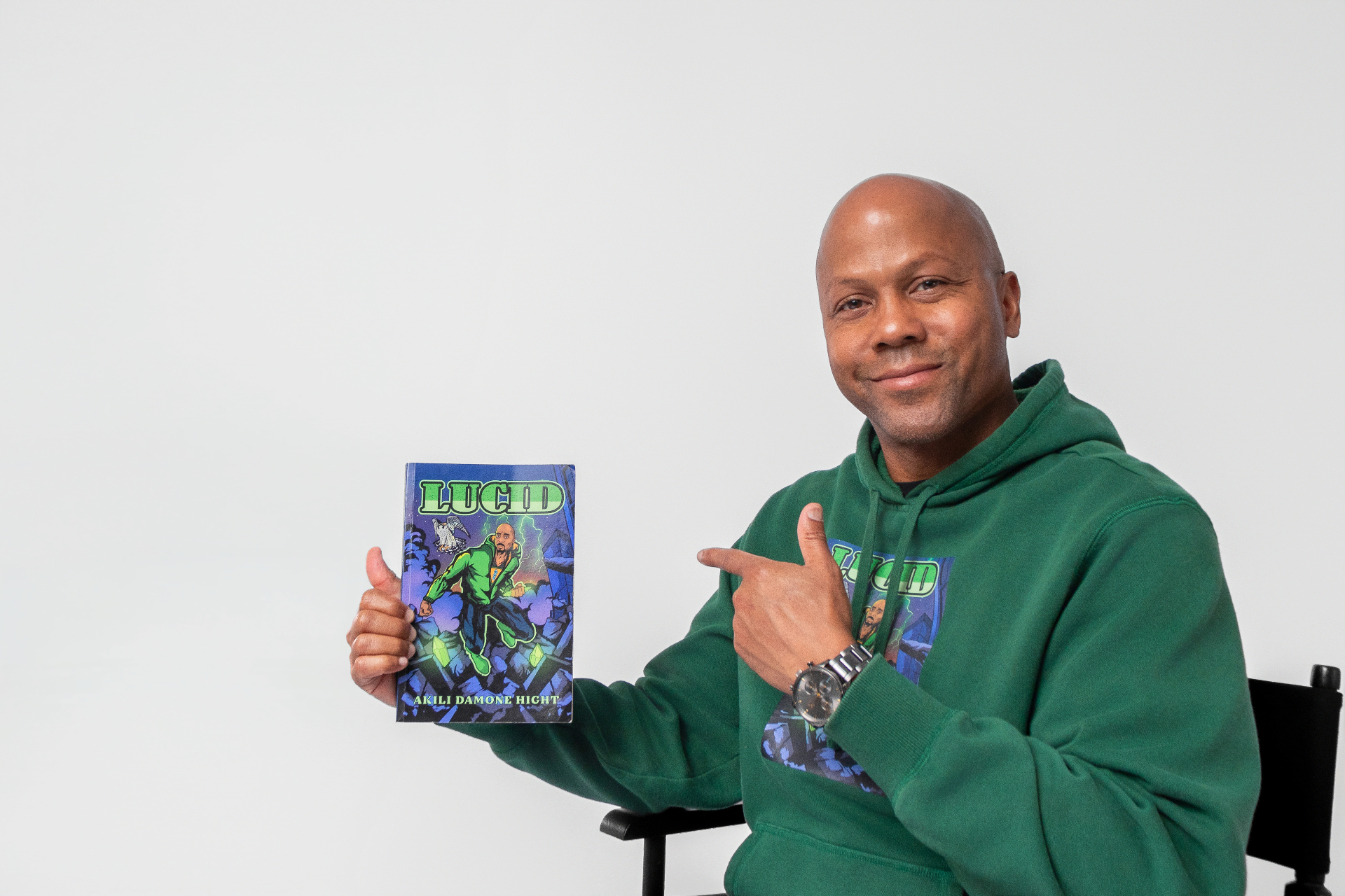 Akili Damone Hight holding the LUCID novel